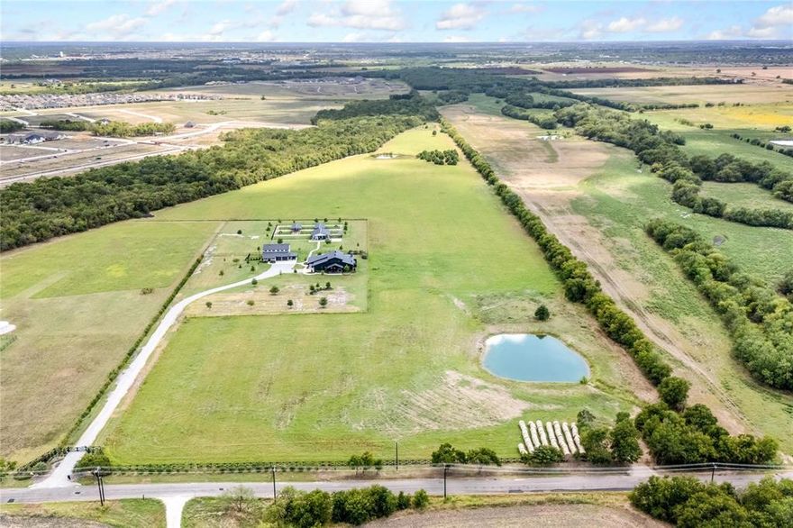 This spectacular 48-acre property offers a rare combination of luxury, functionality, and versatility. No HOA and outside the city limits. 42 acres are currently ag exempt. The remaining 6 acres are meticulously manicured to perfection. A newly built elementary school nearby adds even more convenience to this exceptional location. Property has two ponds

The estate showcases two remarkable homes. The White House (2,766 SF), fully renovated in 2020, is a true masterpiece featuring 3 bedrooms, 3 full and 1 half bath, 2 living areas, a chef’s kitchen, and a 2-car garage. The Black House (2,562 SF), built in 2022, offers 1 bedroom, 1 full and 2 half baths, a spacious family, dining, and kitchen area, a large game-TV room, and a covered patio with an outdoor kitchen, fireplace, and a pool with a hot tub. An oversized garage provides abundant space for vehicles or storage.

The property also includes a versatile barn with a generous front porch—ideal for a business, office, apartment, or dog-boarding facility. A stocked pond filled with bass and striper fish enhances the estate’s natural charm.

Whether enjoyed exactly as it stands or expanded to suit your vision, this estate delivers unparalleled luxury, flexibility, and room to grow. The possibilities here are limited only by your imagination.