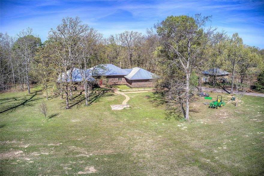 Private 11-Acre Retreat with Pond, Shop and Flexible Living!
Welcome to your private East Texas retreat—where space, flexibility, and quiet living come together on 11 beautiful acres on a cul-de-sac.

Surrounded by mature trees, open pasture, and a stocked pond tucked into the landscape, this property offers the kind of setting that’s hard to find—peaceful, usable land just minutes from town.

The single-story brick home spans over 3,200 square feet and is designed for both everyday comfort and long-term flexibility. With three bedrooms and three updated bathrooms—including two primary suites, the layout is ideal for multigenerational living, extended guests, or creating a private owner’s retreat.

Inside, you’ll find a spacious family room with fireplace, a generous dining area, and a light-filled bonus space that can easily serve as a game room, office, or second living area. Solid construction features, including 2x10 exterior walls, add to the home’s efficiency and durability.

Major updates that have already been handled for you include a metal roof on both the home and garage, a replaced aerobic septic system, and  remodeled bathrooms, allowing you to focus on personalizing the space rather than tackling big-ticket items.

Step outside and the possibilities really open up. The property includes:

A detached 20x30 garage-workshop with electric, 

chicken coop with enclosed pen,

fenced acreage ready for animals, gardening, or recreation, and 

a mix of open and wooded land offering both usability and privacy

Whether you’re looking to create a homestead, need space for hobbies or equipment, or simply want room to breathe, this property delivers a rare combination of land, layout, and long-term value.

Opportunities like this—11 acres, functional improvements, and flexible living space—don’t come along often in this price range.