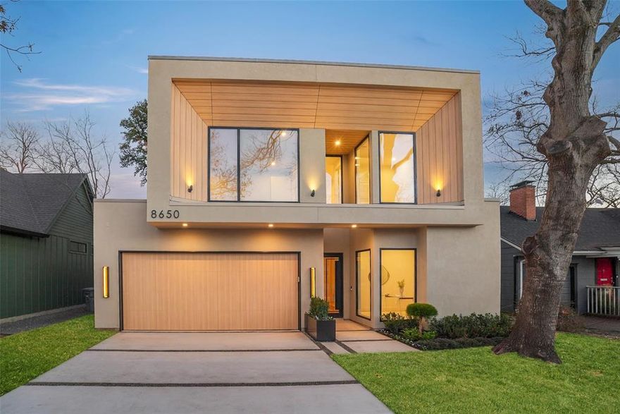 Set along the winding, tree-lined streets of Little Forest Hills, this newly built home feels grounded in a neighborhood known for its sense of community and everyday ease. White oak floors, earthy tones, and clean architectural lines set the tone, with designer finishes and walnut cabinets and accents woven throughout the home. The living space centers around a gas fireplace, creating a comfortable place to unwind. The kitchen is designed for real use, featuring a generous island, walk-in pantry, and a top-tier built-in appliance package including a refrigerator and coffee maker. The primary bedroom is located on the first floor, with additional bedrooms upstairs complemented by well-finished secondary bathrooms. An upstairs media room offers a flexible retreat for movie nights or quiet downtime. Outside, a landscaped yard with a covered patio, outdoor fireplace, and gas grill connection extends daily living outdoors. Lifetime siding and modern rooflines complete a home that feels intentional, comfortable, and easy to live in.