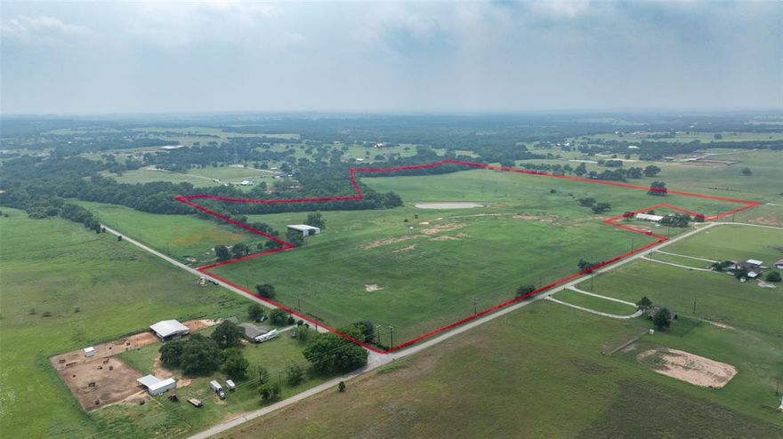 Beautiful 57 acres in BROCK ISD on the corner of Big Valley Circle and Buckner Rd. Secluded pasture land with trees and excellent building sites for your dream home. Large pond and incredible soil are perfect for livestock and agricultural production. TWO water wells, hay barn, access to Coop water and electricity make this an ideal property. The Kickapoo Creek runs along the southern boundary. Property has two access points.....one on Big Valley Circle, and the other on Buckner Rd.
