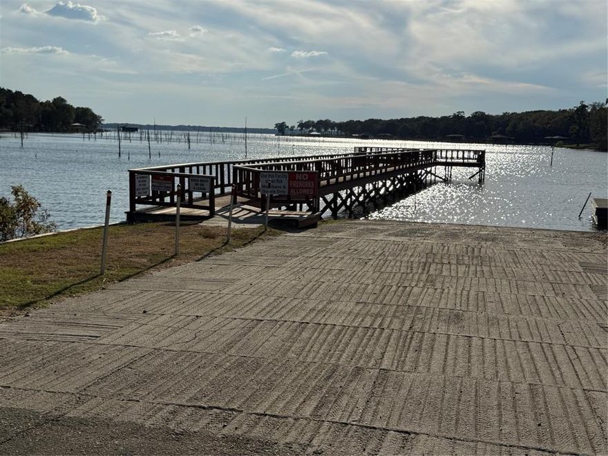 Seller is extremely motivated to sell this great spot located in the gated waterfront community of White Oak Shores. This is a wonderful retreat on Lake Fork! The property includes 5 lots for a total of almost a quarter acre of land. There is a  Park Model home with 1 bedroom and 1 bath, also a comfy living area. The Cedar Creek by Forest River fifth wheel also comes with the property and is perfect for those weekend guests. There is a large covered deck connecting the two living spaces and is great for entertaining. When you are ready to head down to the private dock, community swimming pool, or clubhouse, you can take the EZ Go golf cart that conveys with the property. There is a covered carport for your boat or car. White Oak Shores community features a private boat ramp, fishing dock, community pool and clubhouse.