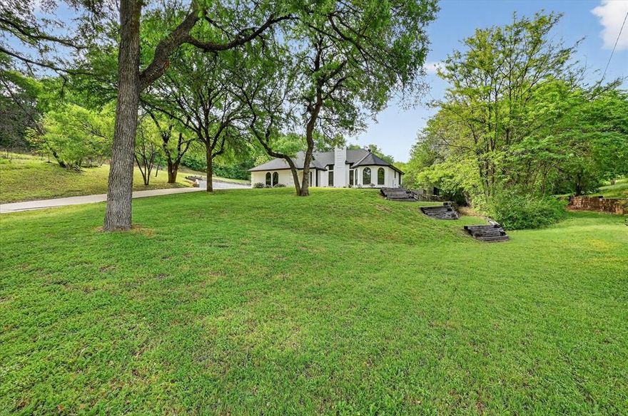 Tucked away on an elevated cul-de-sac in prestigious White Lake Hills, this beautifully refreshed home delivers the rare combination of privacy, character, High quality built in features, and unforgettable lifestyle appeal. The expansive grassy backyard backs to a serene greenbelt, creating a peaceful, nature-filled retreat with exceptional space from neighboring homes, a rare find in Fort Worth. Impeccably maintained and truly move-in ready, the home features fresh paint, a brand-new roof, high-efficiency HVAC (5 years old),Wood burning fireplace, and a charming side garden that adds to its warmth and curb appeal. For those who love to cook and entertain, the centerpiece is a stunning handmade 48” AGA Mercury induction range from Paris, privately made and shipped. This unique range is as unique as the home itself. Homes with this level of privacy, quality, and one of a kind charm rarely become available in Ft Worth. Extremely close to TCU and Downtown. See You Soon...Welcome home!!!