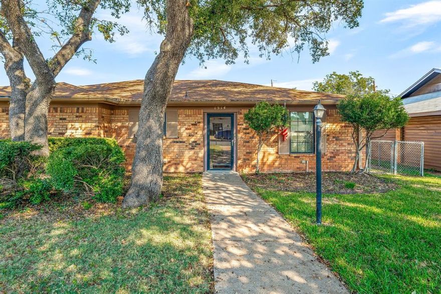 Well-maintained 3-bedroom, 2-bath, 2-car garage home located on a beautiful corner lot with mature oak trees. Entryway with tile flooring, glass storm door, and coat closet in the foyer. This total-electric home offers a functional split-bedroom floor plan, spacious living area with laminate flooring, wood-burning fireplace with brick hearth and wood mantle, built-in bookcase, two tube skylights, a lighted ceiling fan & a French door that leads out to the sunroom with tile flooring and direct backyard access. Dining & kitchen areas have vinyl flooring. Kitchen also features two pantries, solid surface countertops, smooth-top electric range with microwave above, dishwasher, garbage disposal, double sink with window above, a water line for the refrigerator and access to the garage. The full sized utility area is located in the garage which also includes shelving for extra storage, a garage door opener, and an electric water heater. Primary suite includes carpet flooring, lighted ceiling fan, walk-in closet accessed through the ensuite bath with tiled flooring, medicine cabinet, and a walk-in shower with sliding door. Two additional bedrooms with carpet flooring, lighted ceiling fans, ample closet space, and one bedroom has built-in open shelving. Hall bathroom with tiled floor, solid surface vanity, and fiberglass tub-shower combination. Crown molding, 2-inch blinds, ceiling fans, & window treatments throughout. Laminate flooring extends from living room into hallway. The exterior features rain gutters, fenced in yard, automatic sprinkler system and an outdoor storage building. Call us today to schedule a showing!