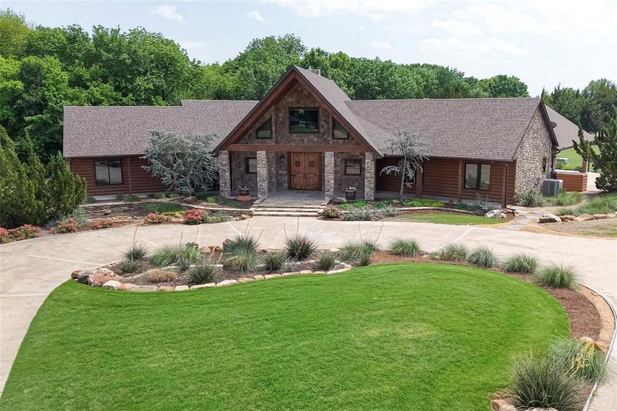Magnificent stone and timber estate located in highly desirable Lucas, Texas. Country living minutes from fine dining and shopping and easy commute to DFW and downtown. The home was featured in Lucas Estate Life Magazine. It is a horseman and nature lovers paradise featuring nearly a mile nature trail enjoyed on foot or horseback that directly accesses Lake Lavon's 26 mile Trinity Trail. The elegant estate is an equestrian's dream, executive home, or family refuge. You will commend every detail, the selective timber, high end finishes to the flawless flow.  Stunning views capture every room with the breathtaking landscape.  The estate features a main house that has several rooms with suede walls, motorized custom window treatments , engineered hardwood flooring, sitting area with incredible views, his and her large walk in closets built with alternative option for nursery or office. Split floor plan has two additional bedrooms and spacious study with builtin cabinets that could be a fourth bedroom.  Upper loft living is a quiet reading room that over looks living area. Large outdoor covered patios offer tranquility, privacy, and custom motorized grass shades for wind and sun block, and mosquito spray system. Propane powered Generac generator which covers main house operation. The oversized carport can seat over 70 and features a built in 20 ft long cypress serving bar with storage. A custom sun and wind shade make it perfect for outdoor entertaining. The estate features a guest house or studio with a full bathroom, closet, hardwood floors and motorized grass shades. This unique home has over four sprawling acres that is fenced and cross fenced. Three stall show barn with small indoor round pen, tack room, full bath, and upstairs living quarters featuring large living area with suede walls, kitchen, full bathroom and utility closet. Main house has 3 baths, square footage includes guest quarters.
