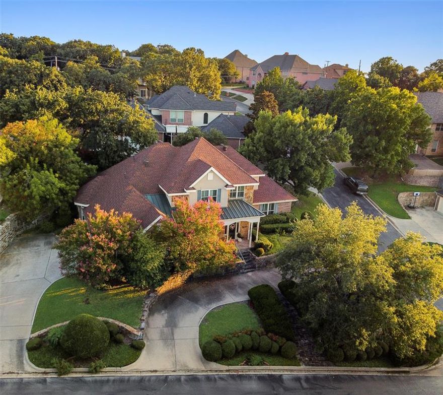Experience a tranquil, private retreat situated right in the vibrant heart of the Metroplex. The entryway welcomes visitors into a warm and inviting interior, with multiple interconnected living areas, perfect for hosting guests and loved ones, offering high ceilings, cozy fireplaces, and a spectacular wet bar. A brilliant sunroom offers even more space to relax and the refined study includes a built-in desk and abundant shelving for your personal library. The gleaming kitchen boasts generous counters, abundant storage in custom cabinetry, a matching paneled refrigerator, built-in appliances, bar seating, and an adjoining breakfast area set in a gorgeous bay window. The spacious primary bedroom includes an opulent en suite bath with a sumptuous oversized tub, separate tile & glass shower, and ample double vanity with makeup counter. Out back, enjoy a private space to unwind, surrounded by manicured greenery and mature trees, with an elevated deck that boasts a well-equipped grilling station. Easy access to Hwy 180 & I20 and nearby splendid Lake Arlington with fishing, boating, parks, and more.