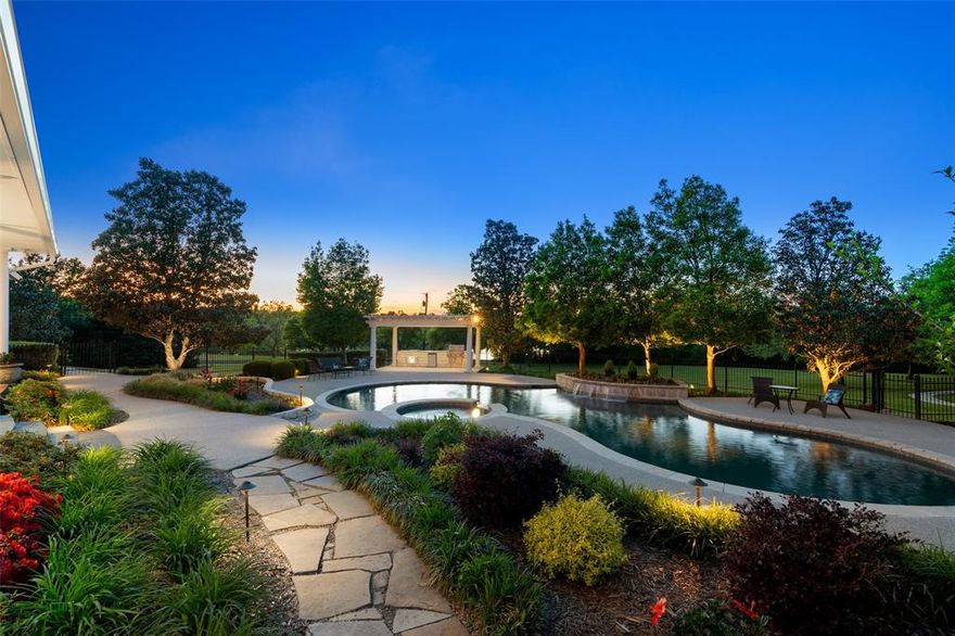 Exclusive Offer: Seller Financing at 4% plus $25K toward updates, creating an exceptional value for this gated 10-acre luxury estate in Sunnyvale ISD! Rare opportunity for buyers seeking acreage, privacy and long-term investment potential near Dallas. Enter through the electric gate and follow a winding, tree-lined drive to a private retreat designed for recreation and entertaining. The resort-style pool and spa anchor the outdoor living space, complemented by an expansive terrace with outdoor kitchen overlooking an open pasture, neighboring pond and private tennis and basketball court. Fenced pasture and a 700+ SF metal barn provide flexibility for equestrian use, hobbies or storage. Inside, the home offers generous scale and a functional layout ready for personalization. The kitchen features a SubZero refrigerator, GE Profile double ovens, walk-in pantry and nugget ice maker. A grand family room with gas fireplace, dedicated media room with GE Monogram beverage center, game room, study with built-ins and fitness room with mirrored walls provide multiple living and entertaining spaces. The primary suite overlooks the pool and includes a Kohler jetted tub and Mr. Steam shower. An oversized 4-car garage with epoxy flooring, slat wall storage, workshop space and built-in safe enhances functionality. Approximately 10-acres with mature trees, open pasture and dedicated walking paths with custom lighting create a rare combination of luxury amenities and usable land. Seller financing available to qualified buyers. Enjoy the benefits of Sunnyvale ISD, known for its 100% graduation rate and ‘Superior Achievement’ financial rating, while embracing the privacy and lifestyle this estate delivers.