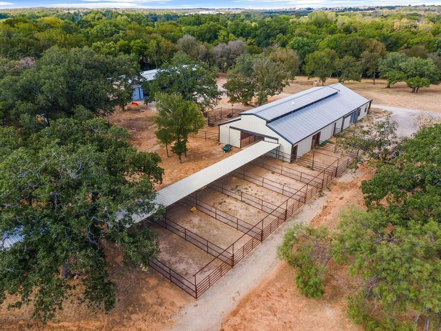 Discover the perfect blend of Luxury and Tranquility! Nestled only 20 minutes away from Will Rogers Coliseum, this exquisite one-of-a-kind custom-built residence sprawls across almost 19 acres. It boasts an impeccable 8-stall show barn with runs with an additional 6 covered traps. Additionally, you'll find a high-end, captivating entertainment area seamlessly integrated with the barn, offering a unique blend of functionality and elegance. State-of-the-art shaded roping arena for you to be able to rope around the clock. The barn has a studio apartment with a full kitchen. The master bedroom features an ensuite bathroom with a soaking tub and a safe room. The property also features a secure gated entrance, top-tier pipe fencing, and a multitude of other amenities. Detached office space for the ability to work from home and have your own space. The meandering live creek adds to the property's natural charm.