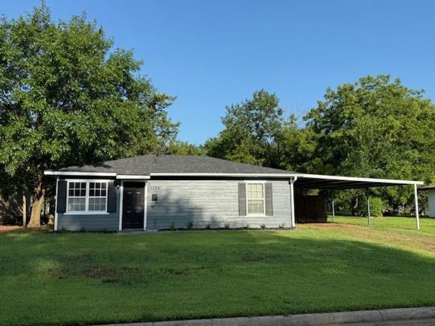 Darling cottage, recently updated with new flooring, interior and exterior paint.  Foundation work just completed.  Spacious open living-dining area with ample natural light create the feeling of more space.  Cute kitchen with gas range and nice cabinetry complete with pass through open area to be able to visit with others while preparing meals. Both bedrooms have new carpet and a nice size.  Full bath.  HUGE, fenced backyard with plenty of room for a shop, play area or a city garden.  Covered parking provided by 2 space carport.  French drains have been installed recently. Washer-dryer space is for stackable unit.