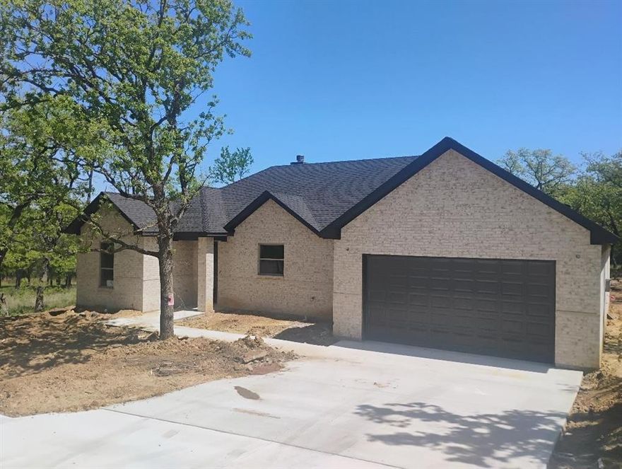 New construction single family home built like a custom home with no corners cut.  Energy efficient will full foam encapsulation and energy efficient heat pump and windows.  Home features an open floor plan with 18' vaulted ceiling in the great room-kitchen-dining room.  The rest of the house has 10 ft ceilings with 8 ft tall doors.  The master bath has double sinks and a large walk-in shower and walk in closet.  The house has laminate flooring throughout with tile in the bathrooms.  Nice covered back porch and two car garage.  The treed lot backs up to a greenbelt so there will be no homes behind you. Take a look at this house and you will see features that others in this price range just don't have.