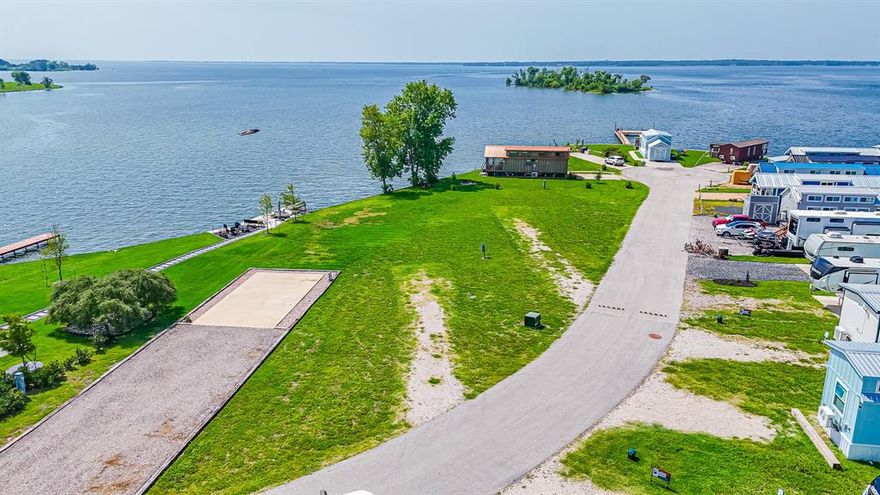 Welcome to your own slice of lakefront paradise at the upscale RV and tiny home resort on stunning Richland Chambers Lake. This premier lot features a RV pad already in place—just bring your RV and start enjoying breathtaking open-water views. With the lake surrounding you on three sides, you’ll catch both sunrises and sunsets in a truly serene setting. The resort-style community offers exceptional amenities, including a clubhouse, swimming pool, laundry facilities, outdoor grill stations, playground, dog park, fishing pier, and cozy fire pit areas perfect for unwinding while watching the sunset. Embrace the lake life you’ve been dreaming of—your waterfront getaway awaits!