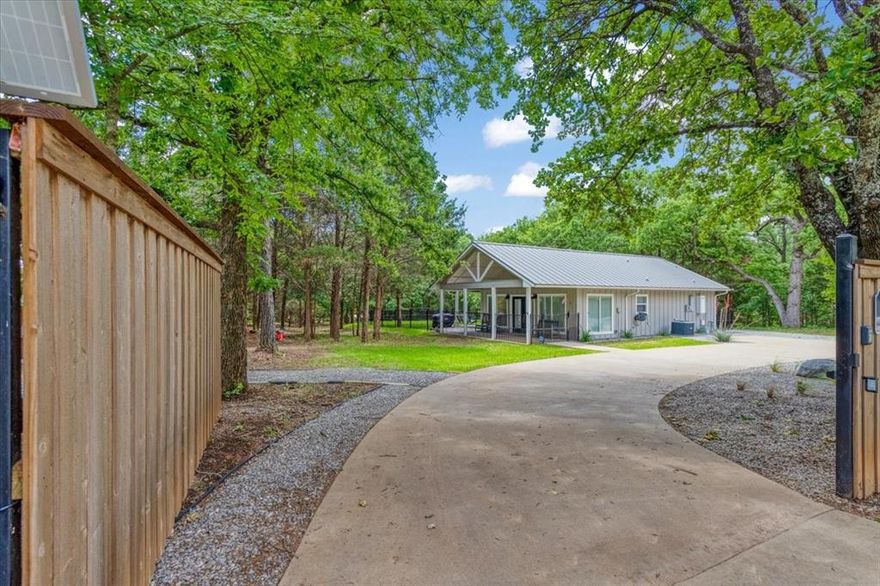 Custom-built modern lake retreat just minutes from Lake Texoma! This beautifully designed and recently updated 1 bedroom, 1 bath home sits on approximately half an acre and offers a rare blend of style and indoor-outdoor living. The open-concept living area features vaulted ceilings, abundant natural light, and a full glass garage door, with an electric screen that opens seamlessly to the covered outdoor living space—perfect for entertaining or relaxing in nature.

High-end finishes throughout include custom cabinetry, a kitchen with plenty of counter space, gas oven, power shades, indoor-outdoor surround sound, a spa-inspired bathroom, soaking tub, tankless water heater, spray foam insulation, and thoughtful design details that maximize comfort and efficiency. Step outside to enjoy the expansive yard, outdoor shower, outdoor living area with a gas fireplace, a peaceful wooded setting, and its all within close proximity to Lake Texoma, marinas, and local recreation.

Ideal as a weekend getaway, full-time residence, or short-term rental investment. The dual power gated entry provides added privacy, with plenty of room to expand or personalize the property. A unique opportunity to own a low-maintenance, luxury home near one of North Texas’ most popular lake destinations. This property includes 5 lots with access from Cameo St as well. Ask about additional lots available. Come see why families love Living on Lake Texoma