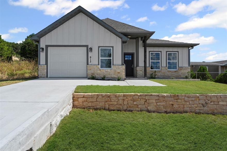 Step into this beautifully designed brand-new home in Comanche Cove, Granbury, where modern comfort and thoughtful craftsmanship meet. With 3 bedrooms, 2 bathrooms, 1,395 square feet of living space, and a 1-car garage, this home is the perfect blend of style, functionality, and convenience.
As you enter, you’re greeted by an open floor plan that seamlessly connects the living, dining, and kitchen areas, creating a warm and inviting atmosphere for everyday living and entertaining. The kitchen is equipped with modern cabinetry, sleek finishes, and an efficient layout that makes cooking and gathering easy. The spacious living area is highlighted by contemporary light fixtures and large windows that allow natural light to fill the space, making the home feel bright and welcoming.
The primary suite offers a private retreat with its own ensuite bathroom, providing both comfort and convenience. Two additional bedrooms offer flexibility whether you need space for family, guests, or a home office. Both bathrooms feature clean, modern designs with quality finishes that complement the home’s fresh, updated style.
Outside, the property includes a 1-car garage for parking or storage, along with a yard that’s ready for your personal touch whether you envision a garden, play area, or outdoor entertaining space.
Located in Comanche Cove, this home offers a peaceful neighborhood feel while keeping you connected to all that Granbury and the surrounding area have to offer. Enjoy quick access to downtown Granbury, known for its historic square, shopping, dining, and entertainment, as well as easy routes to Glen Rose, home of Dinosaur Valley State Park and other local attractions.
This new build is move-in ready and waiting for its first owners. Whether you’re searching for your very first home, a downsizing opportunity, or simply want the peace of mind that comes with new construction, this property is ready to welcome you.