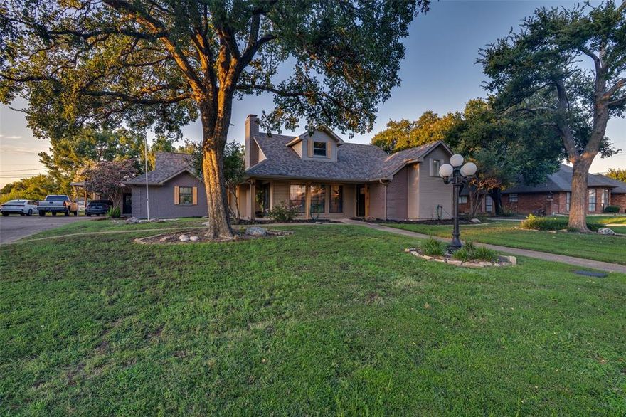 Beautifully updated single-story home situated on an expansive .40-acre lot in sought-after Sachse South Estates. This 4-bedroom, 2-bath residence offers 2,430 sq ft of thoughtfully designed living space blending classic charm with modern comfort. The inviting exterior features painted brick, a wrap-around porch, mature trees, and a wrought-iron fenced yard. Step inside to find fresh paint, updated flooring, stylish lighting, and new hardware throughout. The spacious living area is anchored by a cozy fireplace and flows seamlessly into a renovated kitchen with newer appliances and updated finishes, perfect for entertaining and everyday living. The private primary suite boasts a large walk-in shower, built-ins, and a generous walk-in closet, while secondary bedrooms provide flexibility for family, guests, or office space. Additional highlights include a dedicated office or mudroom, updated bathrooms, and plenty of storage. Outdoors, enjoy a “She Shed” with heat and air, ideal for hobbies or a home office, plus a separate storage building or workshop, dog run, and serene views of horses beyond the back fence. Recent improvements include foundation work and  plumbing with durable PVC for peace of mind. A side-entry 2-car garage and carport provide ample parking. Conveniently located within Garland ISD with choice of schools, this home offers easy access to major roadways, shopping, dining, and entertainment. With its large lot, versatile spaces, and stylish updates, this property is truly a rare find in Sachse!