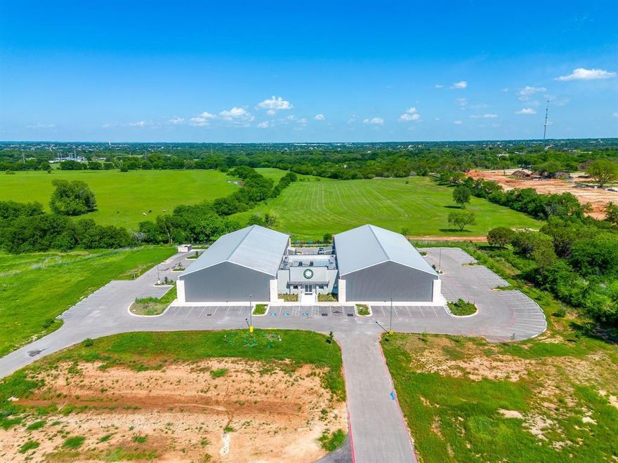 Positioned in the heart of Granbury, this exceptional commercial offering presents a rare opportunity to acquire a premier recreational facility with strong upside potential. Currently operating as the TX House of Pickleball Club, the property features a 24,000 square foot building situated on over 2.5 acres, thoughtfully designed to support high traffic, community driven use.
Inside, the facility is equipped with eight indoor, climate-controlled pro-cushion pickleball courts, creating a year-round playing environment that caters to both casual players and competitive enthusiasts. The expansive layout, combined with over 70 paved parking spaces, allows for seamless operations, tournaments, and event hosting.
Beyond its current use, the property offers remarkable flexibility for investors or owner-operators. Continue building on the momentum of an established and growing pickleball business, or reimagine the space to suit a variety of commercial or recreational concepts. The building’s scale, accessibility, and layout make it well-suited for a wide range of adaptive uses.
Strategically located among national retailers and established residential communities, the property benefits from strong visibility and consistent traffic patterns. The surrounding area is experiencing notable growth, with projected population increases of 11.40% within a 1-mile radius, 12.45% within 3 miles, and 12.65% within 5 miles between 2026 and 2031, further supporting long-term investment potential.
This is a standout opportunity to secure a well-located, versatile asset in one of North Texas’ fastest growing markets. This is where recreation, community, and future development intersect. Call to schedule a showing today!