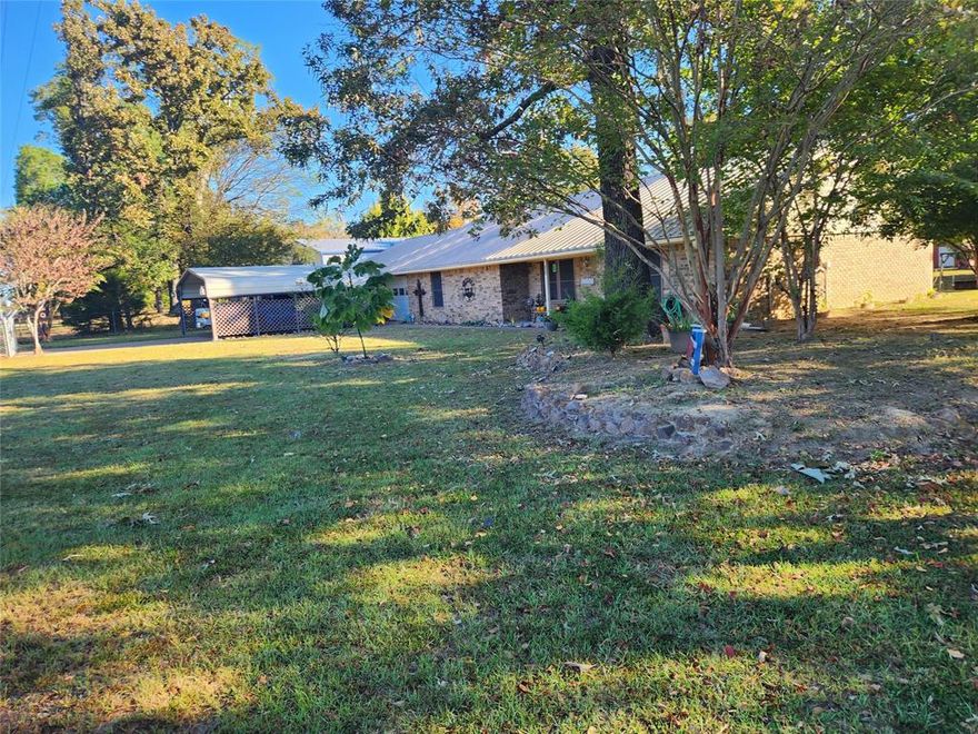 Looking for an affordable home near a Lake Fork public boat ramp? Situated on almost one acre is where you will find this 3-2-2 brick home that features the following: Metal roof, gutters, wood burning fireplace, tile and laminate flooring, split bedroom setup, roomy master bedroom with walk-in closet, large family room, sun room, fenced yard, nice mature shade trees, covered patio, storage building, carport in back for another vehicle or boat plus the public boat ramp is approximately .25 miles from this home.