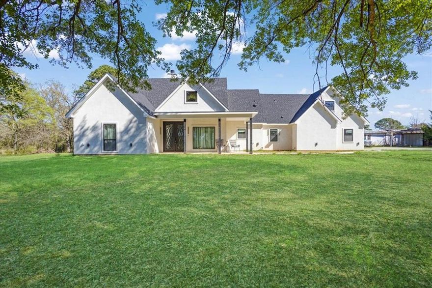 Welcome to country living, where modern-chic meets custom design in this breathtaking home situated on 5 acres with an approx. 4000 sq ft structure that was previously used as a woodworking shop. Step into a grand entrance that leads to an open concept living area offering stunning views of the meticulously manicured grounds. With 4 spacious bedrooms and 2.5 bathrooms boasting high-end fixtures, custom cabinets, luxury abounds in every corner. The primary suite is a true sanctuary with a spa-like ensuite bath complete with dual sinks, a freestanding tub, separate tile shower, & direct access to an covered patio. Within the confines of the sprawling backyard, you'll also enjoy the large shop with an additional bathroom that could easily be converted into a guest quarters or mother in-law suite. Outdoor living spaces await, perfect for hosting gatherings and making lasting memories just a few minutes from Lake Bob Sandlin and Lake Cypress Springs, putting this property in a great location for a weekend getaway or forever home. This property is a must see. Call us today for a private tour.