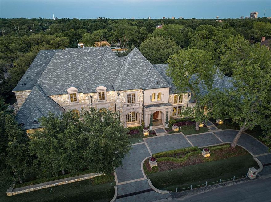 Experience timeless style w this European estate on a .69 AC corner lot in one of Dallas’ most prestigious neighborhoods of Old Preston Hollow. Showcasing elegant craftsmanship w modern appointments + features an open floor plan that flows seamlessly indoors to out. Built by Sharif Munir in '05, the property features a beautiful stone exterior w synthetic slate roof + a circle driveway accented by meticulous landscaping + mature trees. Floor to ceiling windows bathe the home in nat' light + highlight both formal + casual spaces. A beautiful entry has a curved wrought iron staircase with 2-story ceilings + is flanked by formal living + dining rooms. A chef’s kitchen features Viking appliances w custom cabinetry, marble counters + center island, Waterworks fixtures + a walk-in pantry. A spacious brkfst area overlooks a LR w dramatic vaulted ceilings, custom built ins + gas FP. A state of the art media room has a built in screen + tiered seating. An expansive primary suite is located on the 1st floor w a sitting area + beautiful views of the grounds + pool. Primary BA was renovated in '22 w stunning design selections from Ann Sacks tile heated floors to Waterworks fixtures, steam shower + designer lighting. Sep vanities, 2 water closets + an large walk-in closet completes this retreat. A formal study is located off the primary + a guest suite w private BA completes the main level. Connected to the 1st floor by an elevator + 2 staircases, the 2nd floor features a 2nd primary suite w large dimensions that incl a living area + allow for guests or live-ins. 3 add'l guest suites are located upstairs, each with private BAs + walk in closets, + a game room with wet bar + balcony overlooking the grounds. Add'l highlights incl a backyard retreat w covered living area, outdoor FP + kitchen, pool + spa w water features, turfed yard, 4 car grg, Crestron System, Lutron lighting + security cameras. Incredible opportunity for sophisticated living in one of Dallas’ most premier areas.