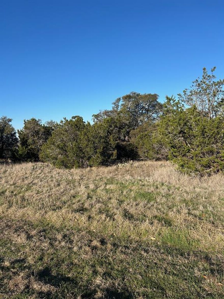 Elevate your lifestyle with this premier 1.98-acre estate homesite, nestled within the rolling hills and 24-hour gated security of The Retreat. This sprawling property offers an unparalleled canvas for those seeking a custom architectural build in North Texas. Situated on a private cul-de-sac with heavily wooded landscapes and breathtaking topography, this is a rare chance to secure nearly two acres of sanctuary in a world-class resort community. Owners enjoy immediate access to an 18-hole championship golf course, two resort-style pools, elite fitness facilities, and an upscale clubhouse—all with no timeline to build. This represents an opportunity to own one of the most secluded and expansive footprints in Cleburne’s most sought-after private enclave.