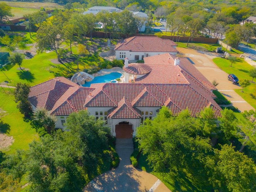 Welcome to 1075 W Dove, an exceptionally rare opportunity to own a sprawling, single story estate nestled on a private, gated 3.5-acre lot in one of the most prestigious areas of Southlake. This gorgeous home has a wonderful layout featuring a large primary suite with sitting area, 4-large secondary bedrooms, multiple living-entertaining areas including a game and media room, a large chef’s kitchen, 4-car attached garage and more. You’ll find the outdoor area equally impressive and perfect for entertaining with features such as beautiful landscaping with mature trees, pool and hot tub, outdoor kitchen and fireplace, tennis-basketball court and play area for the kids-grandkids. If you’re a car lover, RV Owner, or hobby enthusiast, you’ll be blown away by the 4000 SqFt Air-Conditioned detached Garage-Shop with no details left untouched. This is such a unique property that you must see in person to fully appreciate!