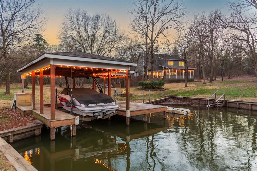 Welcome to 233 E El Dorado—an updated and well-appointed 4-bedroom, 2.5-bath home on a quiet cove on Lake CypressSprings. Sitting on approximately an acre, with added privacy from neighboring homes, this property blends seclusion with premium lakefront living. Inside, you’ll find 2,650 sq ft of thoughtfully designed space. The updated kitchen features granite countertops and opens to a spacious living area with a stunning rock fireplace and gas logs. The primary suite is located downstairs and includes a walk-in closet and private bath. Upstairs offers three guest bedrooms, a full bath, and a bonus media-game area—perfect for entertaining friends and family. Tile flooring runs throughout the main level for easy maintenance, with cozy carpet in the bedrooms and upstairs spaces. Outside, enjoy your morning coffee on the large screened porch or host lakeside gatherings on the multi-level decks. The single-stall boathouse provides easy access to the water, and the 3-car garage with a concrete driveway gives you plenty of space for vehicles, lake toys, and more. Home is being sold fully furnished, making it turnkey and ready to enjoy from day one. Refrigerator, washer, and dryer are included. Whether you’re seeking a weekend getaway or a full-time lake home, this one delivers comfort, space, and classic LakeCypress charm.