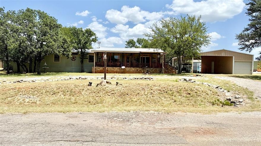 This gem of a home offers the perfect blend of comfort and charm.  Located in a friendly lakeside community, residents enjoy access to a community boat ramp, fishing pier, pool, and parks. It features an open floor plan that creates a warm and inviting space for everyday living or weekend getaways. The living room, dining area, and kitchen flow seamlessly, making it ideal for gathering with family and friends. From the kitchen you have a view of Lake Brownwood, perfect for morning coffee or watching the sunset

Step out to the gorgeous screened-in porch where you can relax and soak in the peacefulness of lake living. The property also includes covered parking and a detached garage with a roll-up door, offering plenty of space for extra storage or the perfect setup for a workshop.

Whether you're looking for a full-time residence or a weekend escape, this home is a true gem.