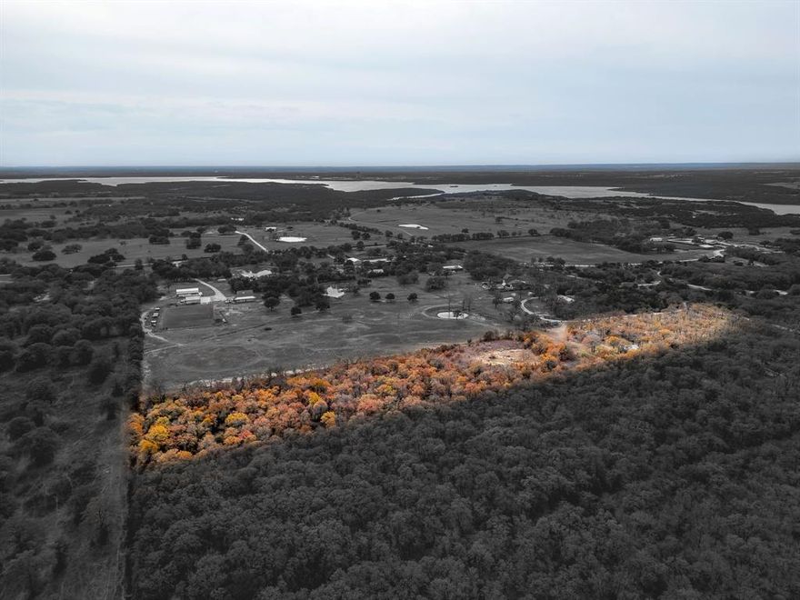 Granbury 7.306 Acres, Custom Brick Ranchette with Guest House, Greenhouse & No HOA. Escape to country living on this beautiful property & plenty of space for livestock. The main home offers 3 bedrooms, 2 baths, & 2 car garage with approx 1960 SQFT built in 2002. Detached 2 car garage includes a well house & room for a workbench. Main home has great bones & ready for your personal touch. Open concept living area features high ceilings, beadboard accents, brick wood-burning fireplace. Kitchen offers granite countertops, stainless steel appliances, custom cabinetry, opening to a cozy breakfast nook. Split-bedroom layout provides privacy, with a spacious primary suite featuring patio access, dual vanities, separate closets, & soaking tub with a walk-in shower. Guest house is a showstopper, complete with a kitchenette, full bath, loft, finished in a rustic cabin style with metal roof, front & back porches & window unit. Outdoor enthusiasts will love the oversized greenhouse with a wall of windows, water bib, & abundant space for gardening projects. Backyard is a gardener’s paradise with shade trees & open space for entertaining. Property features include: New Roof, Brick & Iron Gate Entry, Heavily Treed with Mature Oaks, No HOA, Bring Your Cows, Horses, & Chickens. LOT dimensions: 251 x 1318 x 242 x 1323. Endless potential awaits, whether you’re looking to create your own hobby farm, multi-generational retreat, or a serene rural escape.