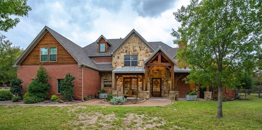Enchanting five bedroom home is nestled on over 1.4 private acres. Be swept away by a two story foyer with cathedral & wood beam ceiling features. Executive study features French doors w private ensuite which may be fifth bedroom. The formal living room offers a floor-to-ceiling stacked stone fireplace. Explore culinary arts w custom wood cabinetry topped w granite countertops, stainless-steel app., including Thermador 6 burner gas range, & abundant island w exotic leathered granite. Family room offers open floor plan & natural stone fireplace. Entertain family & friends in first floor media room w attached exercise room. Luxurious owner suite includes stacked stone fireplace, private ensuite w Hollywood bath, dual sinks, walk-in shower, & his-n-her closets. Upstairs offers 3 bedrooms. Enjoy the pristine backyard by relaxing poolside overlooking water features & separate spa or stay warm on the patio next to the cozy fire! A Dream Home in Carroll ISD!