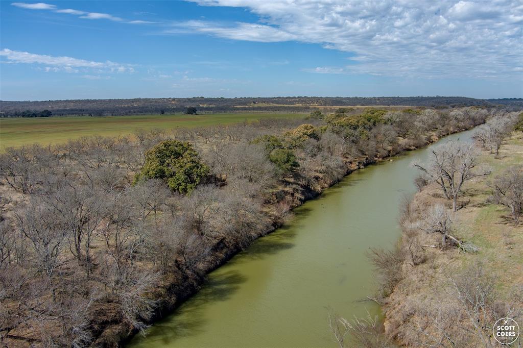 An amazing 1,169 acre working-recreational ranch with over 2 miles of Colorado River frontage. Great fishing, 6 stock tanks + additional creeks & draws. Excellent hunting including deer, turkey, hogs & ducks with good tree cover & brush throughout. There are 2 cultivated fields with 1 being the largest field in San Saba Co. There are elevation changes & beautiful scenic areas along the river with many live oaks & many other native trees. The property also includes a nice 3BR,2B brick home, working livestock pens with a pole barn. Additional 742 acres available with a very nice large home & approximately 700+ GPM water well.