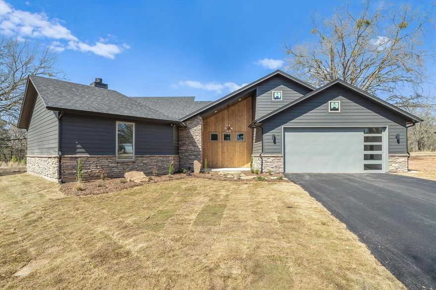 Sitting high on 1.01 acres in Edgewood, just outside the city limits, this modern 3 bedroom, 2 bathroom home offers 1,606 square feet, a two-car garage, and an elevated setting that immediately stands out. Positioned on a hill, it has a commanding presence from the street and feels set apart from everything around it.

The exterior blends stained and painted wood on a quiet asphalt road, but the real highlight is the backyard. A massive wood deck creates a true outdoor living space overlooking your own small pond and open East Texas sunsets. Morning coffee by the water. Evenings watching the sky turn orange over the trees. Private, peaceful, and usable.

Inside, vaulted ceilings and tall windows keep the home bright and open. The living room is anchored by a fireplace and a built-in white oak entertainment cabinet that adds warmth and character.

The kitchen features custom white oak cabinets to the ceiling, quartz countertops, a large island, slide-in gas range, dishwasher, and a floating vent hood for a clean, modern look. A dedicated dining room gives you space to host without breaking up the openness.

A custom entry mud bench makes a strong first impression.

The primary suite offers natural light, a walk-in closet, double vanity with white oak cabinetry, and a walk-in shower with bench and handheld sprayer.

Full irrigation, sod, mature trees, electric central HVAC, and attic access in the garage add everyday practicality.

It also includes a 1-year builder warranty and a 10-year third-party structural warranty for added peace of mind.

Elevated setting. Two-car garage. Fireplace. Oversized deck. Pond views.

This one stands out the moment you pull up.