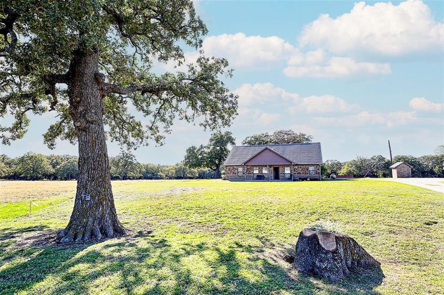 Country living only 10 minutes from HWY 287 allow for easy commute just 60 minutes to FtWorth or Denton. Tucked away on a Dead End road with no thru traffic mature oaks and double gates at entrance allow for privacy and your dream home awaits you! 3 spacious bedrooms office or 4th bedroom can be found in this well designed Custom Home including spacious kitchen, abundant custom cabinetry, large pantry, updated bathrooms and open plan make this home feel grand. Vaulted ceiling with wood beams and hand scraped wood floors are a show stopper! 2 full baths feature soaking tub in master, large ranch style mudroom with half bath, utility sink & space for upright freezer. Enjoy watching turkey, deer and abundant wildlife from the roomy screened porch with ceiling fans. 15x15 barn with concrete floor, water and 10x30 shed off back, 2 additional out buildings include pens! Approx 6 acres coastal for baling & grazing your horses or livestock, ample trees in wooded area allow for perfect hunting!