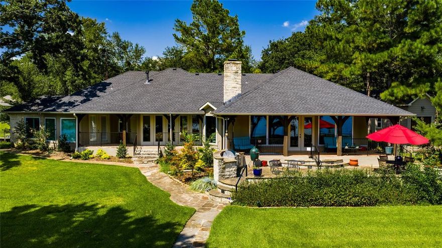 Sprawling one-story home on a stunning open-water peninsula with approx 500 feet of shoreline.   Thoughtfully designed for lakefront living and entertaining, this home offers two fireplaces, and a cooks kitchen featuring quartz countertops, walk in-pantry, and a wet bar.  Private primary suite with updated bath.  Guest suites each have en suite baths.   Additional office and flex room provide versatile space.  Separate guest quarters offer privacy for visitors.  Multiple covered porches overlook the pool with water features.  Detached shop ideal for storage, hobbies and additional parking.  A rare lakefront opportunity with space, privacy and incredible views.