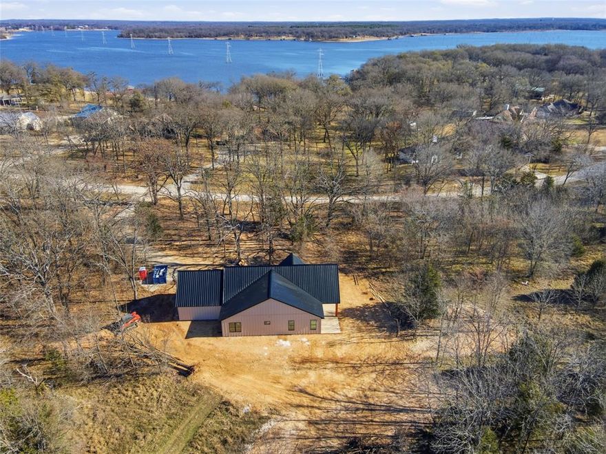 Experience the perfect blend of modern farmhouse charm and lakeside tranquility at 1428 County Road 3503, located in the peaceful Northshores community — a non-HOA neighborhood offering privacy and a relaxed lifestyle. With a private boat ramp just moments away and views of Lake Fork, this home is designed for those who love both comfort and the outdoors.

Currently under construction and slated for completion in late February, this stunning single-story home offers 3 bedrooms, 2 baths, and an open-concept vaulted living area filled with natural light. The vaulted great room features a modern electric fireplace, creating a warm centerpiece for gatherings. The chef’s kitchen blends natural wood tones with sleek finishes — highlighted by a large island, quartz countertops, and custom cabinetry extending to the ceiling.

The split bedroom layout provides privacy for the primary suite, which includes a spacious walk-in closet and spa-inspired bath with dual vanities and a walk-in shower. Two guest bedrooms and a second full bath are located on the opposite side of the home. A walk-in pantry, dedicated laundry room, and 2-car garage add to the functionality.

Enjoy morning coffee on the vaulted front porch or evening sunsets from the patio overlooking the water. With clean lines, timber accents, this home’s architectural design captures the essence of timeless modern-farmhouse living.

Whether you’re looking for a full-time residence or a peaceful retreat near the lake, this new build in Northshores delivers the ideal combination of craftsmanship, comfort, and location — just minutes from all that Lake Fork has to offer. Additional acreage available.