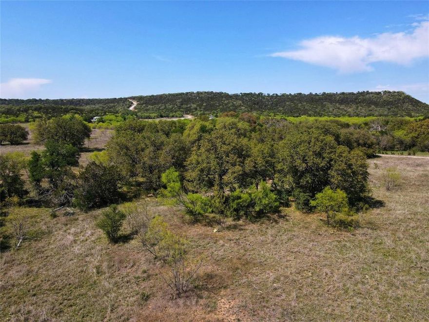 This unique property offers a rare combination of mature trees and wide-open space—ideal for building your dream home or private retreat. Enjoy breathtaking panoramic views of the Palo Pinto Mountains, an abundance of wildlife, and exclusive access to a private park along the scenic Brazos River. With no HOA, you’ll have the freedom to make the space your own, while continued membership in the local grazing association keeps the AG exemption in place. No mobile homes allowed ensures long-term property value and neighborhood integrity. Whether you're looking for tranquility, recreation, or a place to plant roots, this lot checks all the boxes.