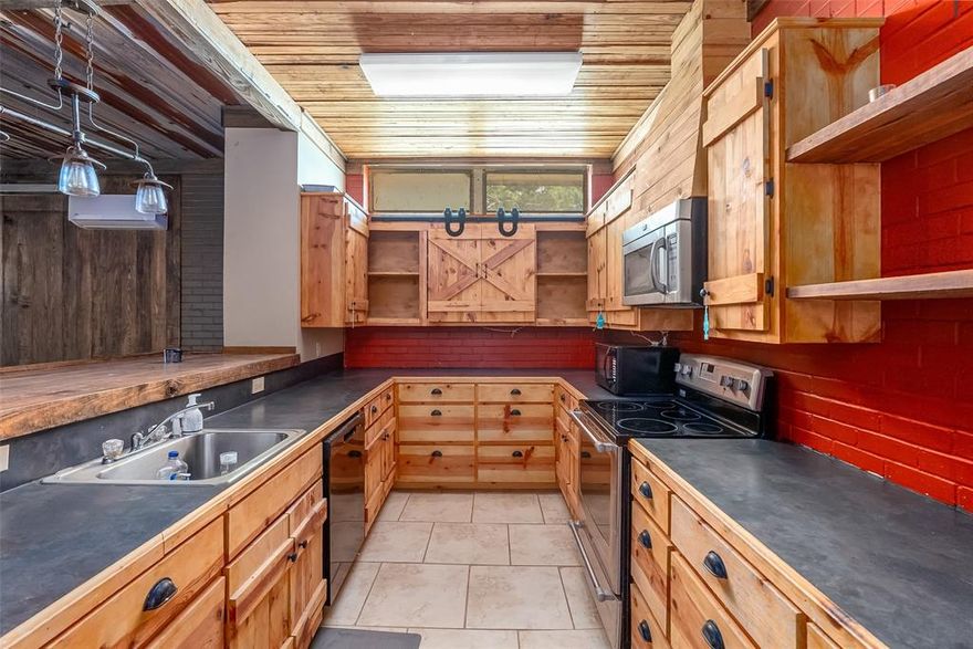 Exceptional Multi-Use Property – 15520 Hwy 9, Athens, LA

Set on 16.7 rolling acres just 7 miles from I-20, this rare estate transforms a former elementary school into a versatile equestrian and multi-functional property offering over 37,000 square feet of space across multiple buildings.

The expansive main building blends historic charm with modern amenities, featuring 7 flexible rooms ideal for bedrooms, offices, or studios. A private one-bedroom apartment with a full kitchen offers comfortable onsite living. Two former classrooms have been converted into a spa area with an indoor hot tub and spa pool (may convey). A full-size gymnasium includes a professional basketball court, bleachers, locker rooms, and a concession stand. Two kitchens, six bathrooms, and 10 individual showers support large groups or commercial use. Dedicated office space and preserved classroom architecture add character.

The secondary building is designed for horse lovers with 7 extra-large stalls, 2 bathrooms, rustic living quarters with pine-accented walls, a full kitchen, game room, bunk room, tack room, and spacious hay storage. Additional concrete-floored barn stalls increase boarding capacity.

Outdoor features include a spring-fed stocked pond, abundant wildlife, agricultural workshop with bathroom, secure Ponderosa fencing with electric gate, asphalt circle drive for easy access, and a five-foot no-climb fence enclosing the rear pasture.

This exceptional property is ideal as a luxury equestrian center, rehabilitation facility, sports camp, retreat venue, or multi-family rural homestead. Offering a unique blend of history, function, and expansive space, 15520 Hwy 9 is a rare investment opportunity.