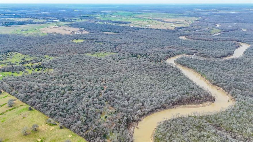 Just an hour south of Dallas, this expansive and secluded property offers over 440 acres of unspoiled countryside, bordered by the scenic Trinity River. A true haven for outdoor enthusiasts and sportsmen alike, this land is rich with wildlife, making it ideal for hunting, nature exploration, or simply escaping the city to reconnect with the great outdoors. The terrain is beautifully wooded, with miles of winding trails that lead you through peaceful forests, open clearings, and picturesque river views. At the heart of the property sits a charming, private cabin — the perfect place to relax after a day of adventure. Enjoy the quiet serenity and soak in the views of your very own wilderness retreat. With no restrictions, this land is as versatile as it is beautiful. Use it for hunting, livestock, recreation, or as a long-term investment with limitless potential. Properties of this size and freedom rarely come available — don’t miss your opportunity to own a piece of Texas paradise.