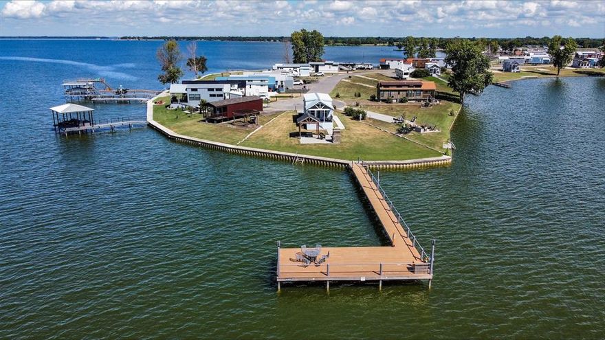 Awesome waterfront lot on RC lake with apx. 100 foot pier that you can fish from, with an island view! You'll enjoy Lake Life in this Tiny Home Community! Home is move-in ready complete with all the furnishings that are included. Stainless steel appliances, corner decorative FP with blower, movable kitchen island and so much more! Multiple windows to let the natural light in, very nice bathroom with step in shower and vanity. Stack washer and dryer connections in pantry. Sprinkler system uses either fresh water or lake water. Outdoor living is set up with a firepit, covered area, pizza oven and a very nice storage building for housing all the outdoor toys! 

Possible Seller Financing with adequate down payment and agreeable terms. 

All information is deemed reliable and correct but should be verified by buyer or buyer's agent.