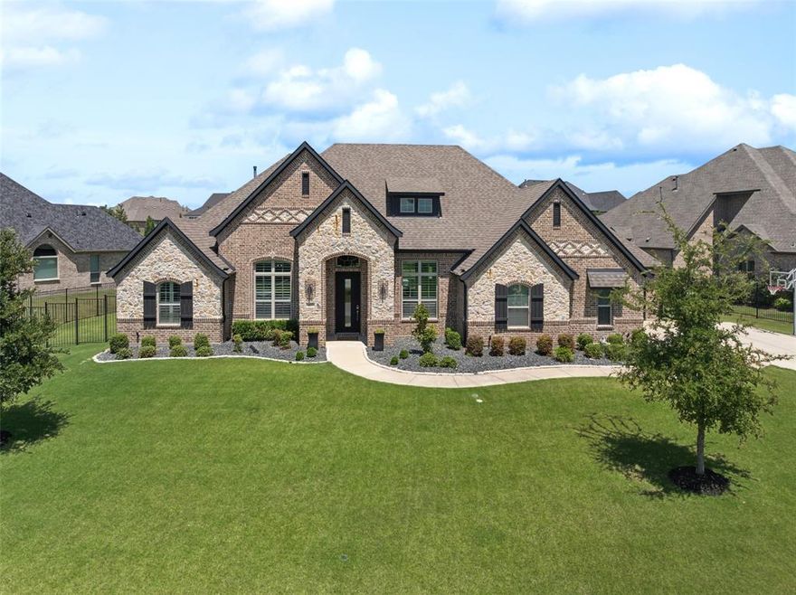 Welcome to your private retreat in sought-after Brockdale Estates, perfectly situated within acclaimed Lovejoy ISD.  Nestled on a generous half-acre lot, this beautifully maintained and freshly painted one-story home offers luxury, comfort, and exceptional outdoor living. The backyard is a true retreat, featuring a stunning pool and hot tub designed by Riverbend Sandler Pools, complete with a water feature, basketball net, and travertine decking. Entertain year-round on the oversized covered patio with fireplace—perfect for relaxing evenings or hosting guests. Inside, you'll find hand-scraped hardwood floors, plantation shutters, coffered ceilings, decorative lighting, and recently updated carpet throughout. The layout includes a dedicated home office, formal dining area, and a spacious living room with a cathedral ceiling accented by a wood beam, tiled gas fireplace, and expansive windows overlooking the backyard. The open-concept kitchen is a chef’s dream with a large bar for seating, a farmhouse sink with hands-free faucet, double ovens, 5-burner gas cooktop with pot filler, walk-in pantry, and a convenient butler’s pantry. A large utility room includes a sink and space for an extra refrigerator, along with abundant storage throughout the home. The primary suite is a peaceful retreat with tray ceilings and backyard views. The en-suite bath offers a soaker tub, frameless glass shower with dual shower heads including a rain feature, large walk-in closet, and separate linen storage. With four additional bedrooms—one ideal as a flex room—this home provides plenty of versatility. Enjoy proximity to Lake Lavon, nearby trails, and even a local mini beach. This Brockdale Estates gem combines upscale features with a relaxed, outdoor lifestyle—schedule your private showing today!