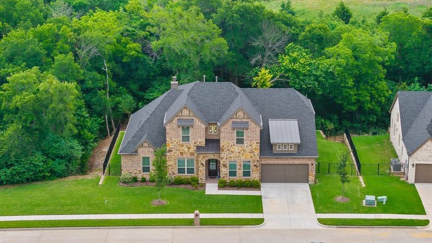 Welcome to luxury living in The Bridges at Preston Crossing, where privacy meets elegance on one of the largest lots in the community; spanning 0.84 low maintenance, acres. This exceptional two-story home is nestled among mature trees and bordered by a peaceful natural creek, offering a serene, private backdrop with only one direct neighbor.
Inside, you'll find a thoughtfully designed open layout ideal for both relaxed living and entertaining. The chef’s kitchen features quartz countertops, a spacious island, and extensive cabinetry, all flowing seamlessly into the inviting family room and outdoor living space.
The first-floor primary suite is positioned to take full advantage of the tranquil views, complete with an oversized walk-in shower and a massive walk-in closet. A guest bedroom with a private ensuite is also located downstairs, perfect for visitors or multigenerational living. Showings begin Sat, Oct 25

Upstairs, a versatile game room creates the perfect spot for movie nights, gaming, or a kids' retreat. Additional bedrooms, each with walk-in closets, ensure everyone has their own space.

With a dedicated home office, flexible living spaces, and a setting that offers both comfort and seclusion, this home combines thoughtful design with natural beauty. Immaculate and like new, with some builder warranty still in place, this property is move-in ready and waiting to be enjoyed.