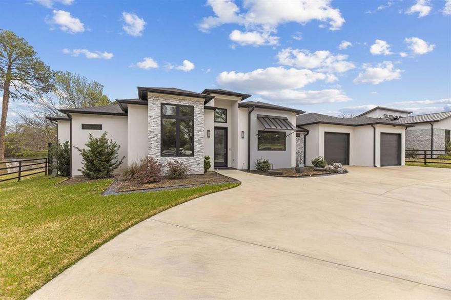 Custom home priced to impress, 1515 N Fielder seamlessly blends luxury, convenience, and space for multi-generational living. This thoughtfully designed home features dual primary suites on opposite sides of the property, each with private ensuite bathrooms, walk-in closets, and direct access to the backyard retreat. The open-concept layout showcases an oversized, commercial-grade kitchen with dual 6-foot islands, built-in wine fridge, double ovens, and a walk-in pantry—perfect for any chef. The spacious laundry room offers ample storage, folding counters, and easy access to cleaning tools for everyday functionality. Designed for entertaining, the backyard is your very own oasis. Premium Andersen patio doors lead to a screened-in patio with surround sound system, ceiling fans, fire pit, and electric retractable screens for year-round comfort. The expansive smart pool is enhanced by a cascading water element, volleyball area, and hot tub seating, all framed by Mediterranean palms. A putting green with mini golf features completes this private outdoor retreat, enclosed by an 8-foot composite privacy fence. The front exterior showcases a modern blend of stucco, stacked stone veneer, and metal detailing, complemented by an iron-gated luxurious circular driveway. Ideally located just minutes from AT&T Stadium, Globe Life Field, Texas Live, UT Arlington, major highways, and DFW Airport, this home offers both privacy and accessibility on an oversized 0.34-acre lot. Additional highlights include energy-efficient windows, spray foam insulation, tankless water heater, smart gate, and sprinkler system for easy maintenance of property grounds.
Welcome home!