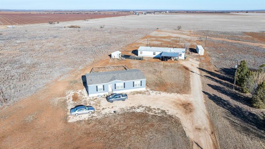 Cash Only – Sold As Is, Where Is.
Unique opportunity on 2.5 unrestricted acres outside city limits, just 15 minutes from the Data Center. Ideal for multi-generational living, workforce housing, or income producing potential, with room to add another residence, shop, or animal pens.
Property includes two manufactured homes, each with its own electric meter and septic system (shared water meter).
Main home (real property): 2001 Town & Country manufactured offering approx. 2,304 sq ft, 4 bedrooms, 3 full baths, plus flex room that could serve as a 5th bedroom or office. Central HVAC indoor and outdoor units and mini split (in Primary) installed in 2024. Metal two-car carport. Livable now with cosmetic update potential. 
Second home (personal property): 2023 Champion Homes Prime Series offering approx. 1,577 sq ft, 3 bedrooms, 2 baths. Has its own septic, electric meter, 911 address, and tax parcel. Will convey by Non-Realty Addendum and Bill of Sale unless otherwise negotiated.
Each residence has its own fenced yard.
No known restrictions — excellent flexibility and long-term potential. No Existing Survey we will need a new one for exact boundaries. Chicken coop on property (chickens may remain if desired) Negotiable items may include Conex container, appliances, and some furniture.  Traditional financing will not qualify