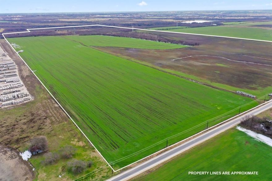 The property spans approximately 327.56 acres within the Gunter ETJ. It is situated on the east side of Wall Street, about one mile north of FM 121, benefiting from high traffic and visibility. This area is experiencing rapid growth and is close to several planned residential developments. The land offers extensive frontage along Wall Street and is level and open. It also features a private well, with the eastern boundary lined by dense trees and a creek running through it, alongside two tanks near the creek. The property is presently used for agricultural purposes. All information to be verified by Buyer or Buyer's agent. 

The only known restrictions are related to the site's characteristics and utility access.