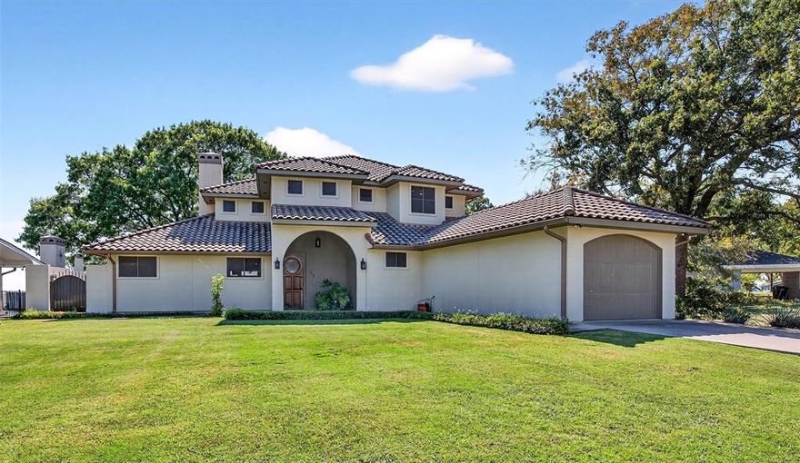 A Mediterranean Masterpiece on the Water - Lake Life Starts Here! Experience the art of lakeside living in this gorgeous Mediterranean-inspired property where timeless stucco architecture & breathtaking views create a sense of classic elegance! Step inside to Saltillo tile flooring & your eye is immediately drawn to a wall of windows framing the tranquil lake just waiting for you to enjoy! The kitchen is a true centerpiece of the home, designed for both beauty & functionality, offering a huge island with extra seating giving an effortless layout perfect for gathering & entertaining! Throughout the home, whether you are upstairs or downstairs, walls of windows reveal views that are nothing short of mesmerizing! Whether you’re enjoying a quiet morning coffee or unwinding at sunset, light dances across the water & sparkles like tiny diamonds providing a stunning backdrop for every moment & creates a sense of peace that words can barely capture. Stepping outside you could enjoy walking down to the water or relaxing in one of several outdoor living spaces.  There are two covered deck areas & an open air living space with fireplace & wood-fired pizza oven — ideal for alfresco evenings with family & friends.  Relaxing in the hot tub is also an option! This is more than a home... it’s an escape — and a place where Mediterranean charm, modern comforts & the timeless beauty of the lake create a lifestyle beyond compare... all waiting for you to call it yours!