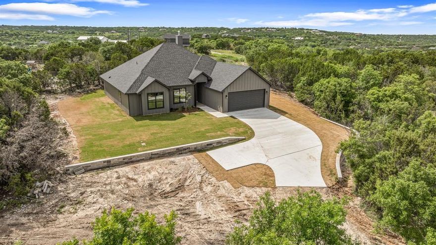 Builder is offering 10K in buyers concessions with acceptable offer. New Build Modern Farmhouse by Flippin Custom Homes! Located on a sprawling 1-acre lot in desirable Mountain Lakes Ranch, this stunning 4-bedroom, 2-bath home offers the perfect blend of modern design and farmhouse charm. Step inside to an inviting open concept layout featuring vaulted ceilings, a cozy fireplace, and high-end finishes throughout. The chef’s kitchen flows seamlessly into the living and dining areas, perfect for entertaining or everyday living. The primary bedroom retreat offers a private sanctuary with a spa-inspired ensuite and walk-in closet. Additional features include foam insulation for energy efficiency and year-round comfort. Relax on the covered back patio and enjoy peaceful views of the surrounding wildlife and rolling landscape. Built with the exceptional quality and attention to detail that Flippin Custom Homes is known for, this home is ready to welcome you! Don't miss your chance to own this brand-new modern farmhouse in beautiful Mountain Lakes Ranch!