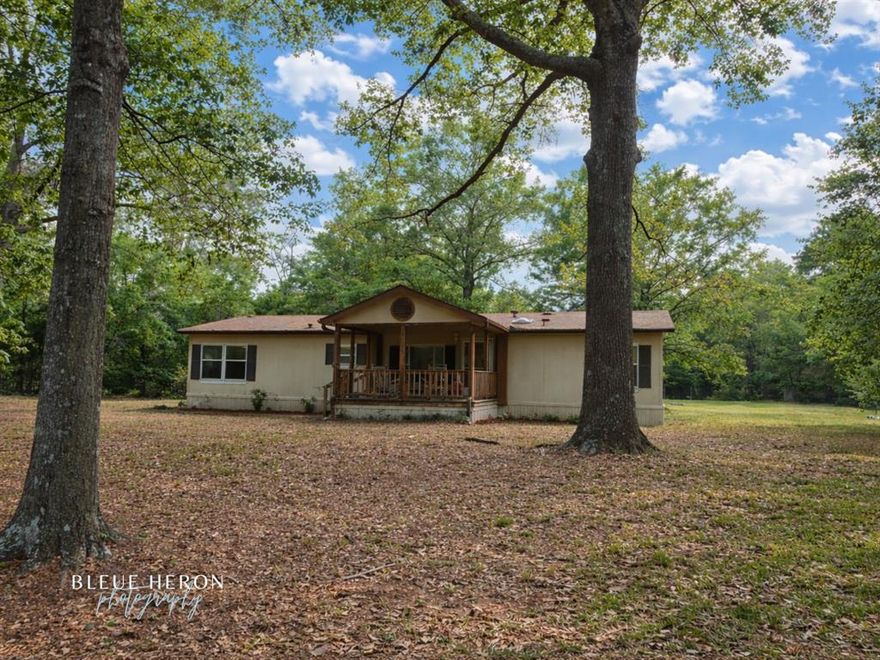 Tucked away on nearly 2 acres in the peaceful Quiet Place In The Woods subdivision, this property offers the perfect blend of privacy, space, and comfort.

Step onto the beautiful front porch and take in the quiet surroundings—this is country living at its best. With plenty of shade trees and room to roam, you’ll have space to relax, entertain, or simply enjoy the outdoors.

Inside, this very well maintained home features updated flooring, upgraded plumbing, a newer roof, and more—giving you peace of mind and move-in ready convenience.

Outside is where this property really shines:
Workshop with electricity – perfect for projects, storage, or a home business
Additional barn in the back – ideal for equipment, hobbies, or animals
Nearly 2 acres – room to expand, garden, or just enjoy the space

If you’ve been looking for a quiet retreat with land, functionality, and charm—this is it.