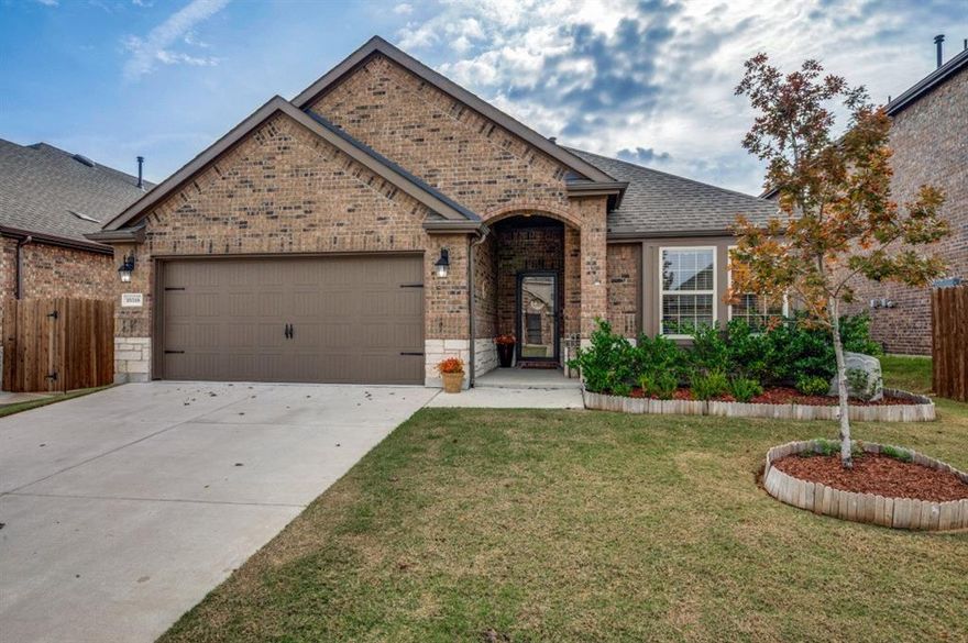 Welcome to this stunning brick-and-stone single-story home in the sought-after Silverado West subdivision of Aubrey, TX. A beautifully landscaped walk-up leads to a covered entryway, setting the tone for the charm and warmth found throughout.  Inside, the open floorplan highlights the cozy ambiance of the stone fireplace with gas logs, which can be enjoyed from the main living areas. The raised hearth and custom mantle make the fireplace a standout focal point. Matching stone on the breakfast bar continues the rustic feel, adding character and visual appeal.  The kitchen offers abundant cabinetry, generous countertop space, and a gas cooktop, sure to please the home chef. The rustic theme flows into the primary suite, where a barn door opens to the en suite bath featuring dual sinks and an updated oversized frameless shower.  Step outside to enjoy a spacious covered patio with ceiling fan, plus an adjacent pergola—ideal for relaxing outdoors or entertaining guests. The large backyard provides ample space for play, gatherings, or furry friends.  Residents of Silverado West enjoy a vibrant community filled with amenities, including a pool, pickleball courts, playground, and water play area for the young or young at heart. With easy access to major roads, you’ll appreciate the convenience of getting where you need to go while still enjoying the peaceful charm of Aubrey living.  This home beautifully blends comfort, character, and community—don’t miss your chance to make it yours!
