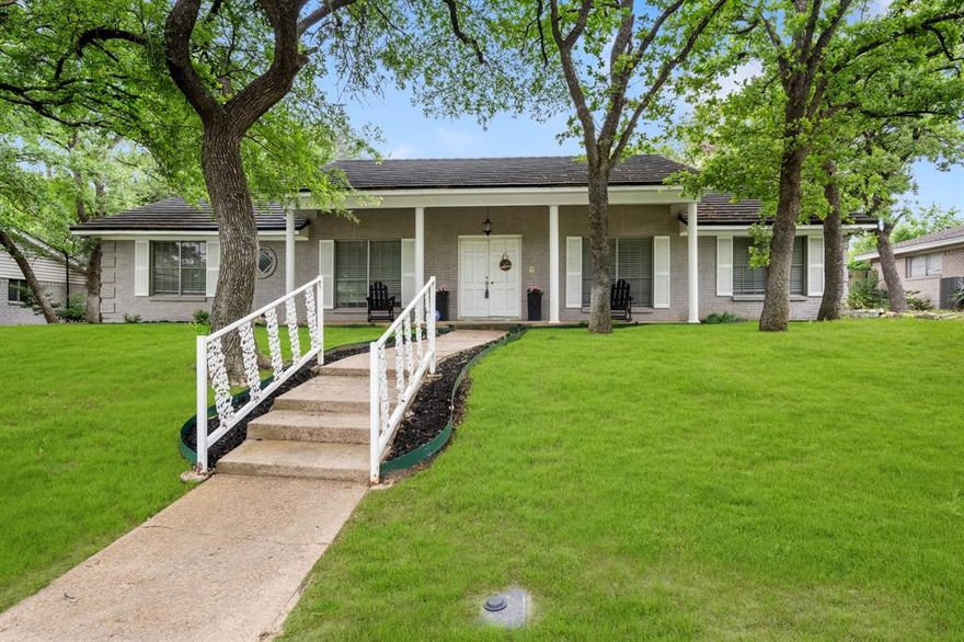 Classic charm meets everyday functionality in this beautifully updated one-story home in sought-after North Arlington, zoned to highly rated Butler Elementary School. Ideally located within walking distance to Shackelford Junior High School and Lamar High School, and offering quick access to Interstate 30 for an easy commute. Nestled among towering mature trees, this home welcomes you with a charming covered front porch and inviting curb appeal. Inside, you’ll find a spacious and functional floorplan featuring two large living areas, a formal dining room, and a sunny breakfast area—perfect for both everyday living and entertaining. Fresh interior paint and new wood-look flooring flow throughout the main living spaces, creating a clean, updated feel. The open-concept kitchen is designed for connection and convenience, showcasing crisp white cabinetry, beautiful granite countertops, and great sightlines into the living areas. Built-ins add character and practical storage throughout the home. The private primary suite is complemented by two additional bedrooms and a second full bath. A huge utility room offers extra space for storage—an added bonus not often found. Step outside to enjoy a covered patio and a versatile rear-entry driveway—ideal for entertaining or play. Additional updates include a durable metal shake roof (2023) and a new water heater, providing peace of mind for years to come. With its classic style, modern updates, and unbeatable location, this North Arlington gem is one you don’t want to miss!
