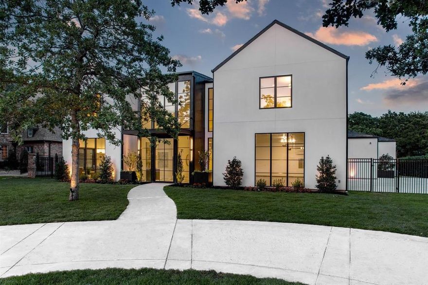 Experience elevated living in the prestigious Westwyck Hills of Southlake with this stunning modern French masterpiece! Step through the striking 22.5-foot glass entryway, framed by a solid pivot door, and be greeted by a breathtaking checkerboard marble foyer that sets the tone for the home’s exceptional design. The expansive main living area is bathed in natural light, anchored by a sleek double-sided fireplace that gracefully separates the living space from the formal dining area. High vaulted ceilings with wood beams and arch entryways in most of the main areas further amplify the sense of grandeur and openness. Designed for effortless entertaining, the home features a custom bar and a sophisticated wine room. The chef’s kitchen is a true culinary masterpiece, equipped with top-of-the-line Thermador appliances, endless Cambria quartz countertops, exquisite porcelain finishes, and abundant storage space.The luxurious primary suite offers a private retreat, complete with a cozy fireplace and an expansive ensuite bath. Indulge in a spa-like experience with his-and-her vanities, dual showerheads, a serene garden tub, and a massive walk-in closet that is every wardrobe lover’s dream. For wellness and recreation, a glass-enclosed gym or golf simulation room enhances both fitness and leisure. Upstairs, a spacious living area with a wet bar and three beautifully designed bedrooms provide comfort and style for family or guests. Step outside to the outdoor veranda, where a cozy fireplace and automatic phantom screens offer both ambiance and privacy. The resort-like backyard is an entertainer’s paradise, featuring a stunning pool with a waterfall, promising the ultimate outdoor living experience. This home is meticulously designed to elevate your lifestyle. Located in the heart of Southlake, it offers convenient access to premier shopping, dining, and entertainment, all just minutes away.