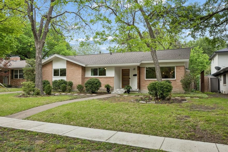 Tucked into the desirable Lochwood neighborhood in East Dallas, this is the kind of home that feels like an escape without ever leaving the city. Positioned across from a lush greenbelt and surrounded by mature trees, the setting offers a peaceful, nature-filled backdrop that’s hard to find in Dallas. Light-filled living spaces highlight hardwood floors and a highly livable open floor plan. The kitchen has been thoughtfully updated with granite countertops, refreshed cabinetry and backsplash, gas range, and a large island with generous storage all opening seamlessly to the dining area, where a fireplace and wall of built-in cabinets add warmth and character. The spacious primary suite offers a calm, private escape, complete with an updated bath, oversized shower, and walk-in closet. Two additional bedrooms offer flexibility for guests, a home office, or hobbies. Located just minutes from White Rock Lake, the Dallas Arboretum, and Downtown, this home offers the perfect blend of privacy, convenience, and East Dallas charm.