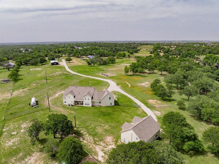 PRICE REDUCED! INCREDIBLE OPPORTUNITY TO OWN A ONE OF A KIND PROPERTY with TWO single family homes on 10 acres (9 are ag exempt)! Rent one and live in the other, or move in parents or your 20 somethings! Main house is 4950 sf, 7 BD, 4 BA plus multiple living areas, an office up and down, and a media room! Kitchen is adorned with granite countertops, stainless appliances, double ovens, and an island! Also includes a full upstairs kitchen, two staircases, laundry rooms up and down, and 2 fireplaces! Back house is 1800 sf, with a large 2nd living area upstairs, and has 3 BD (potential 4th) and 2 BA, and a 2 car garage plus additional space in the garage for a workroom! The home also includes a workshop, RV or boat parking, and lots of space for gardens! Low utility bills realtor can access! Both homes received a new roof in 2022!