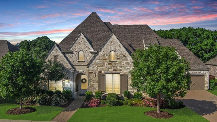 A perfect 10 in Prosper's Whitley Place! Total privacy backyard boasting an impressive waterfall swimming pool & spa with sweeping greenbelt views on a .36 acre lot. Exceptional Huntington floorplan is an entertainer's dream, known for its dramatic architectural features ~ cathedral beamed ceilings, picture windows capturing the views, upper balcony, outdoor living patio with a 2nd fireplace & built-in barbecue grill, custom cabinets & built-ins throughout, decorator hardware, mirrors & fixtures, extensive hardwood floors, plantation shutters...absolute comfort & luxury on both levels. 5 spacious bedrooms, including primary & guest suite down, each with an ensuite full bath; executive study; downstairs media room has a projector, screen & components that all convey; big gameroom with a kitchette-wetbar & adjacent large storage room; 3 powder baths including a pool bath; split 4-car garage with a Tesla charger. Signature chef's kitchen showcases a 48 inch built-in refrigerator, quartz counters, pendants, hidden hinges, spice cabinets, soft close doors & drawers, basin sink, lighted glass cabinet doors, 6-burner gas cooktop. 2 dining areas including a custom hutch in the breakfast area. The spa-like primary bath features a custom California closet, a freestanding spa tub, frameless shower, linen towers. Upper library & 2 homework stations + 5th bdrm used as an exercise room with padded LVP flooring. Whitley Place's rolling terrain, fishing ponds, playgrounds & 2 swimming pools + elementary school in the community make it a desirable place to live. No MUD or PID! Prosper is the ultimate suburban address. Make this your family's best move ~ picture perfect everyday in a peaceful & tranquil setting.